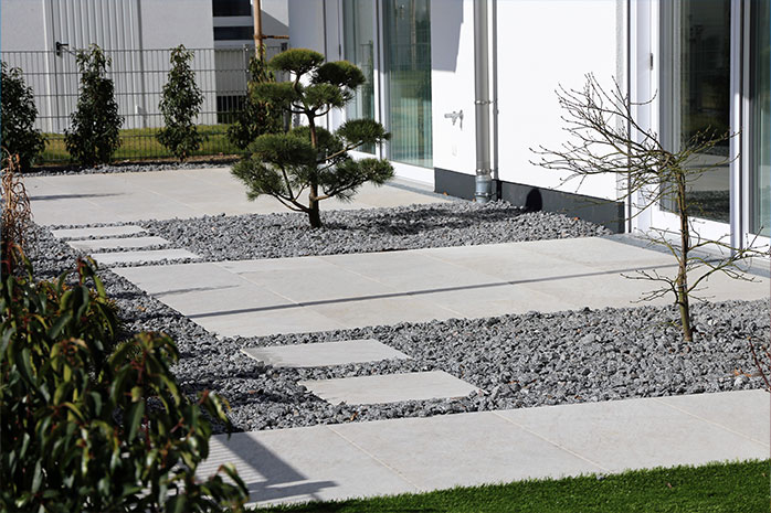 Modern terrace design with concrete, stone and sparse planting